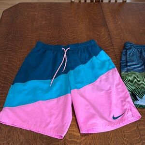 Two pairs of Nike swim trunks. Both size medium.